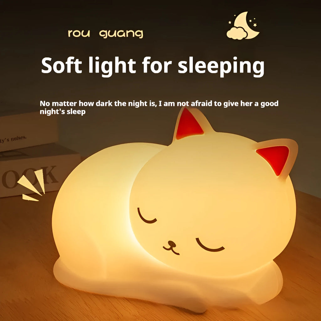 Sleepy cat shaped silicone induction night light with white glow on table