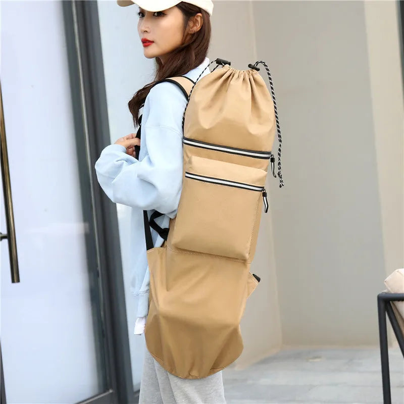 Black waterproof nylon bag for carrying a skateboard and fishing rod, shown with yoga mat.