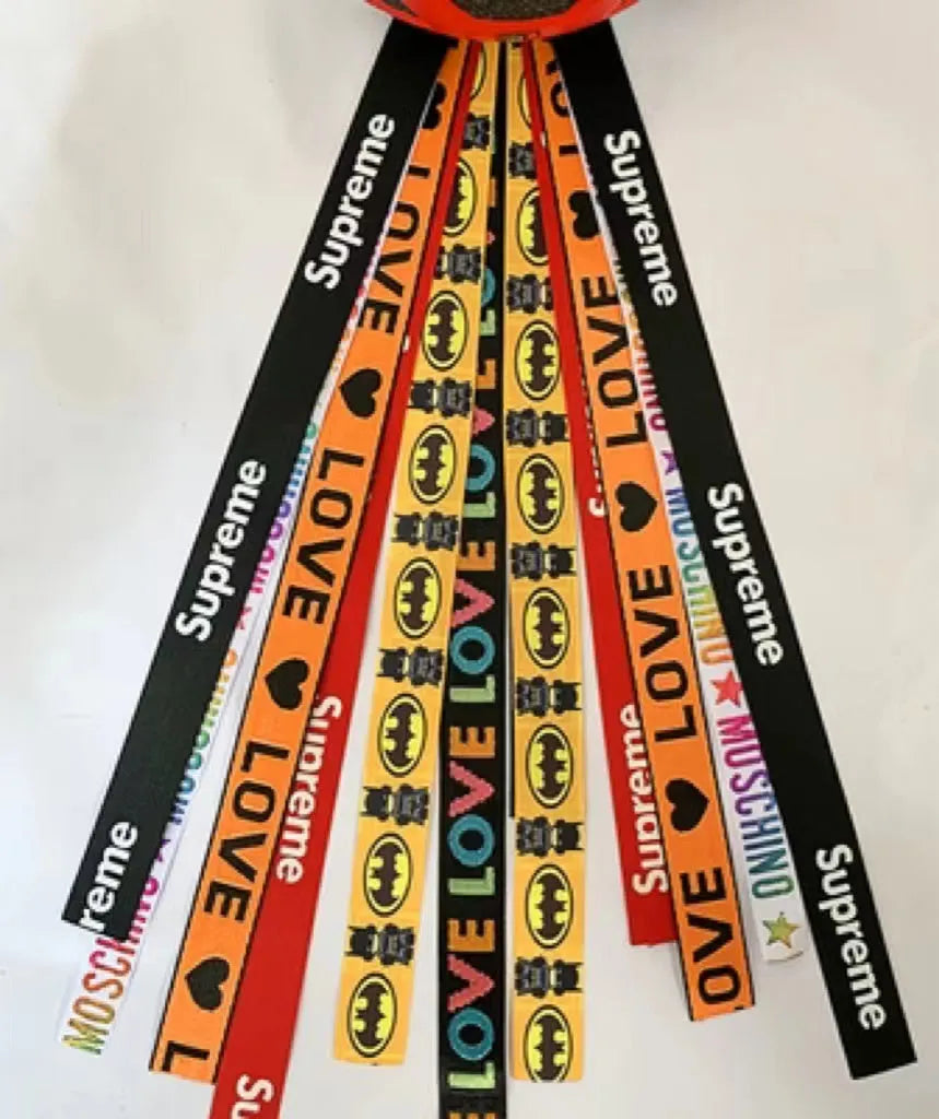 A decorative ribbon streamer for attaching to a child's roller skate or ski helmet, shown in a selection of colours.