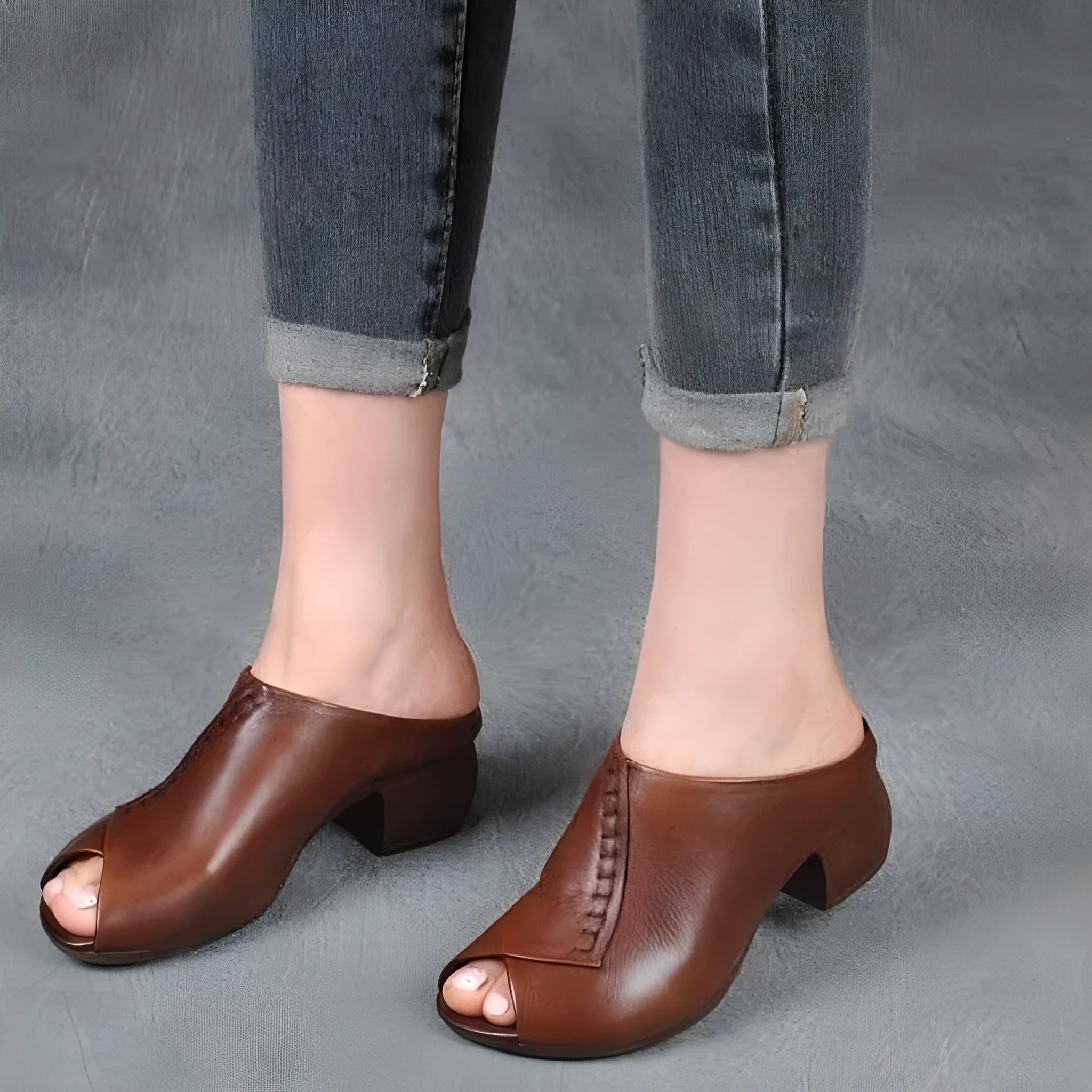 Women's black square heel peep-toe slippers with a fish-mouth scaffold design on a white background.
