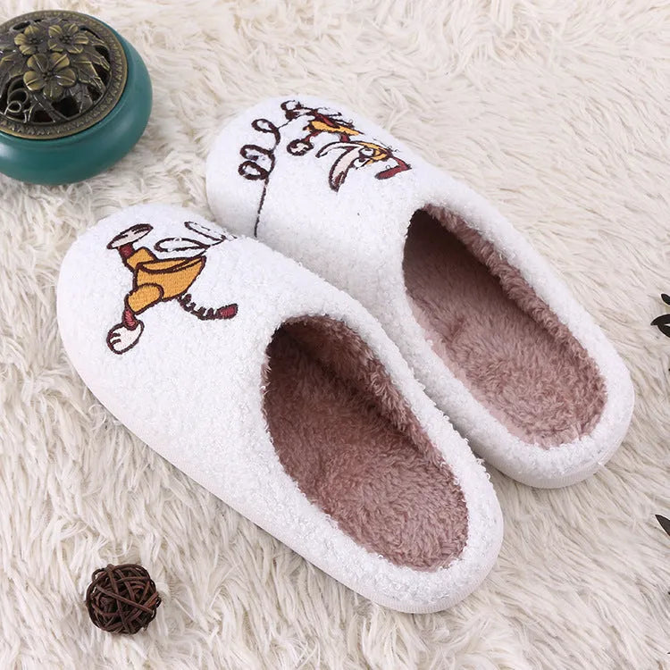 White fluffy slippers with cartoon pattern, rubber soles, and artificial wool lining