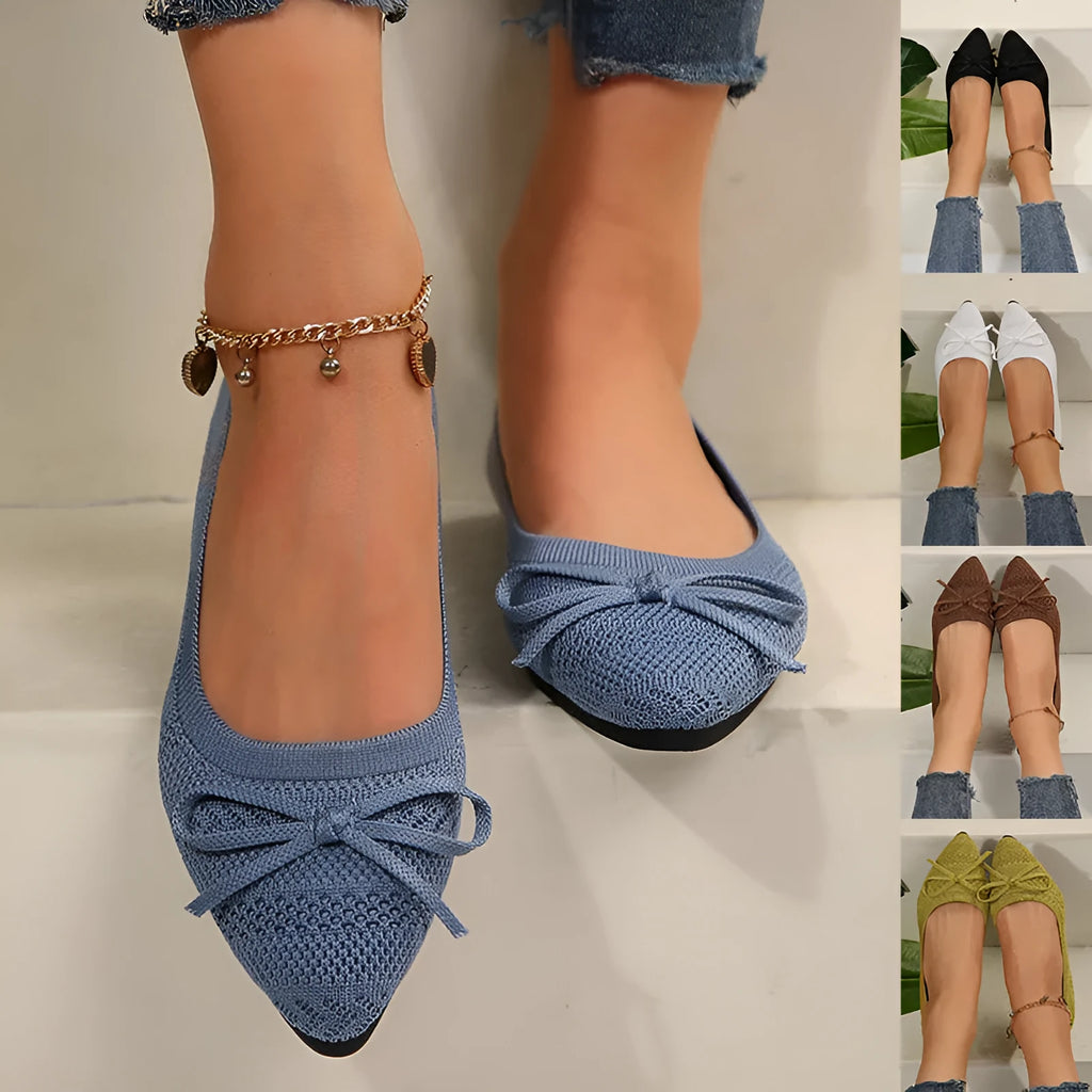 Women's blue knitted flat loafers with a pointed toe and a decorative bow on the front