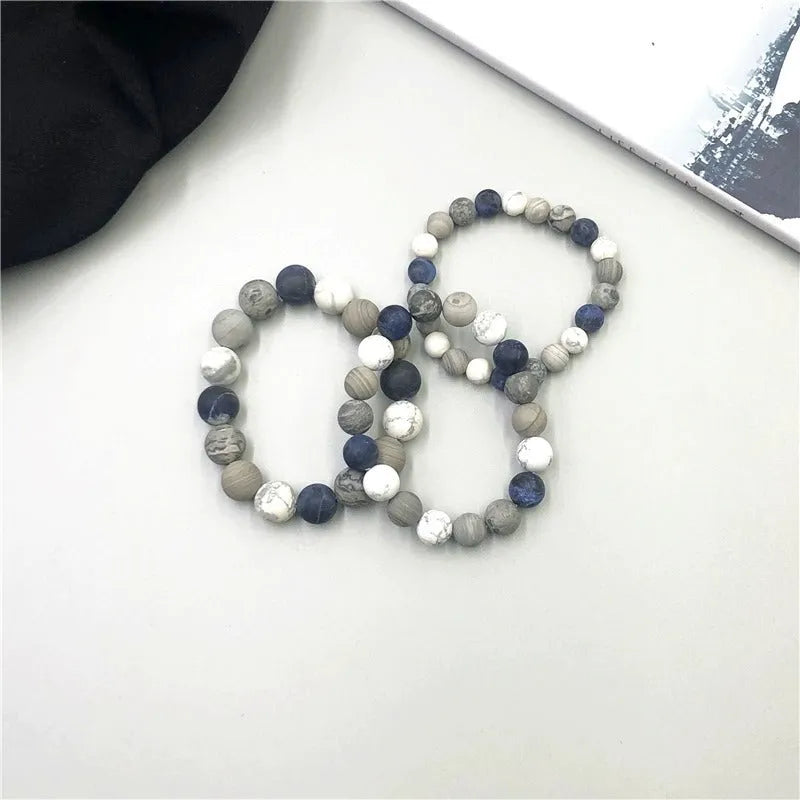 Handmade planet stone men's bracelet in U-shape, S228 Universe Wind design on wrist.