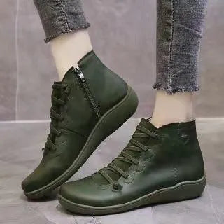 Women's ankle boot in leopard print with round toe and flat wedge heel on a rubber sole.