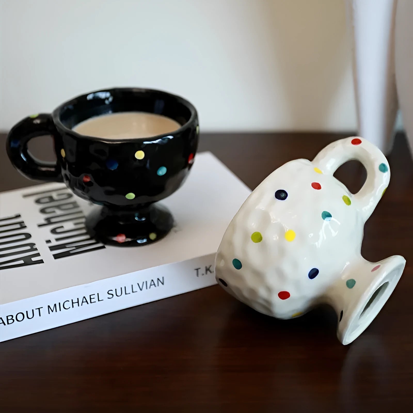 Irregularly shaped hand-pinched ceramic mug in a solid colour, shown on a plain background.