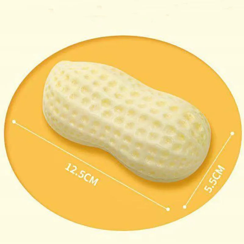 Yellow TPR peanut-shaped dog chew toy with squeaker on a white background