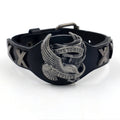 Black leather bracelet with a geometric alloy eagle decoration, showing the band's width variation.
