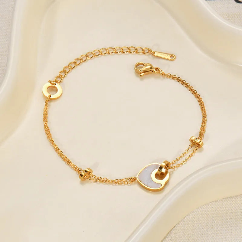 Women's silver stainless steel bracelet with a double-layer red heart charm and magnetic clasp.