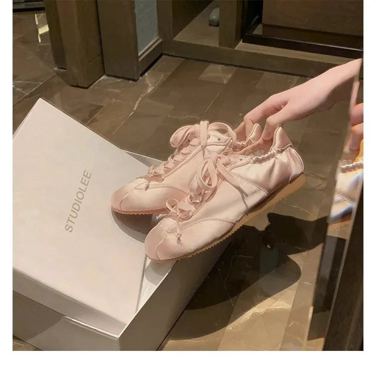Women's satin ballet flat shoes with round toe and lace-up front in champagne pink colour
