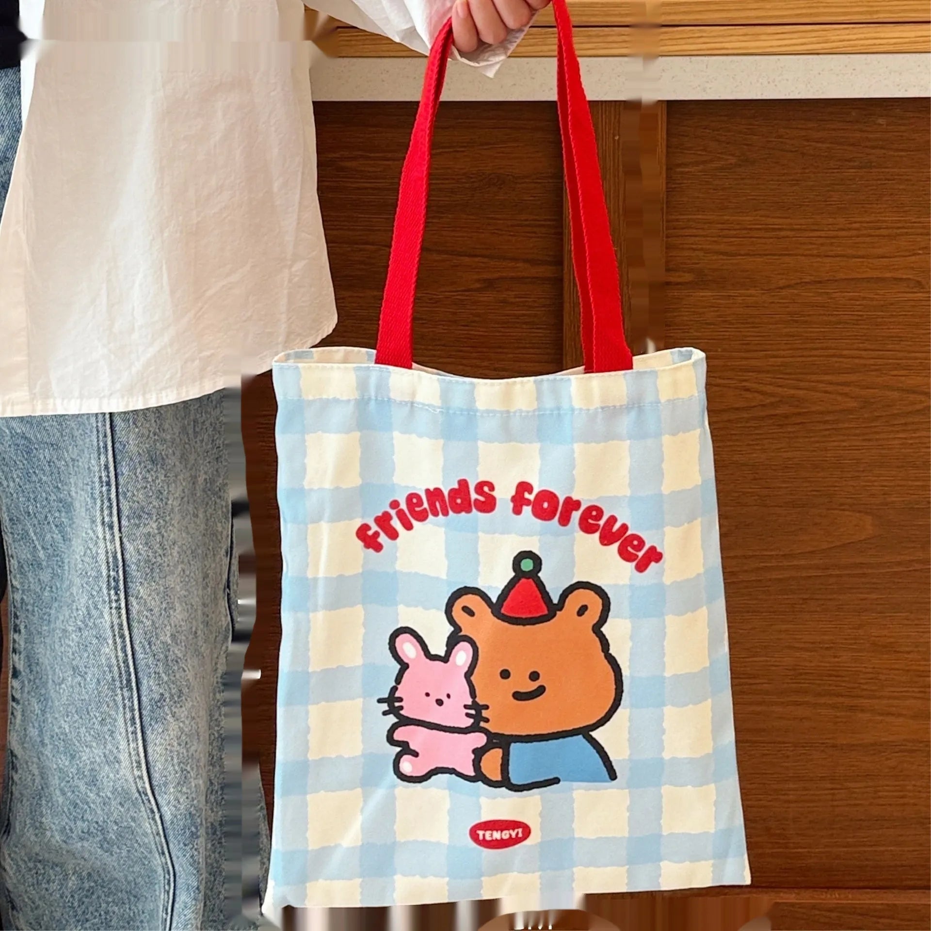 Cartoon print canvas handbag showing colourful design with 30x36x24cm dimensions