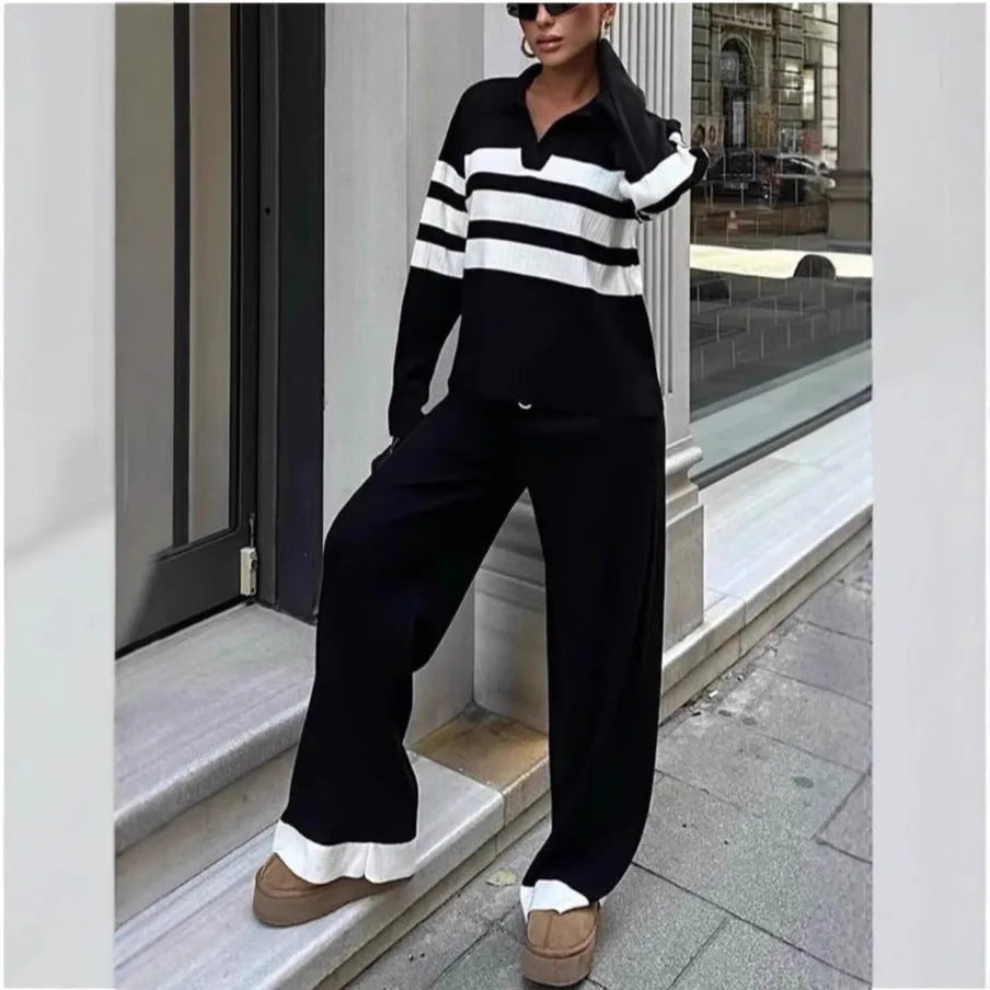 Women's black and white striped polo collar knitted top with matching trousers, a casual two-piece set.