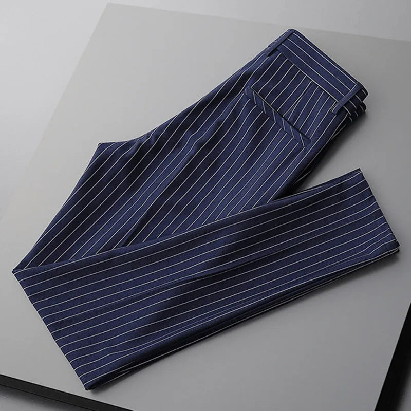 Man wearing thin striped loose-fit casual trousers in a drape style, shown in black and white colour options.