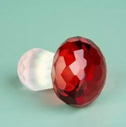 Colourful geometric crystal mushroom decoration in transparent, green, red, or yellow, 40mm by 53mm.