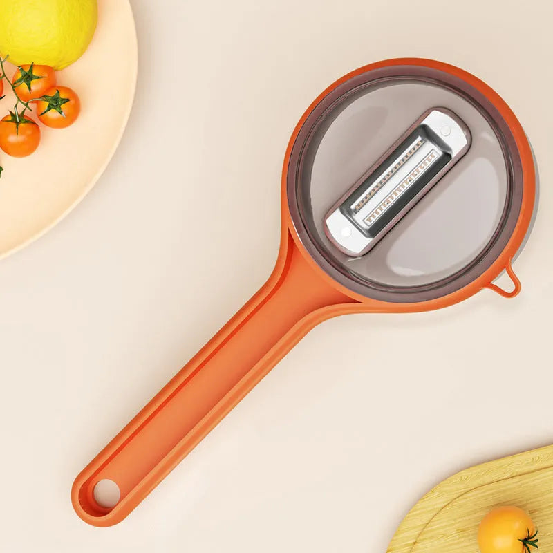 Kitchen peeler with integrated storage bucket in light green colour