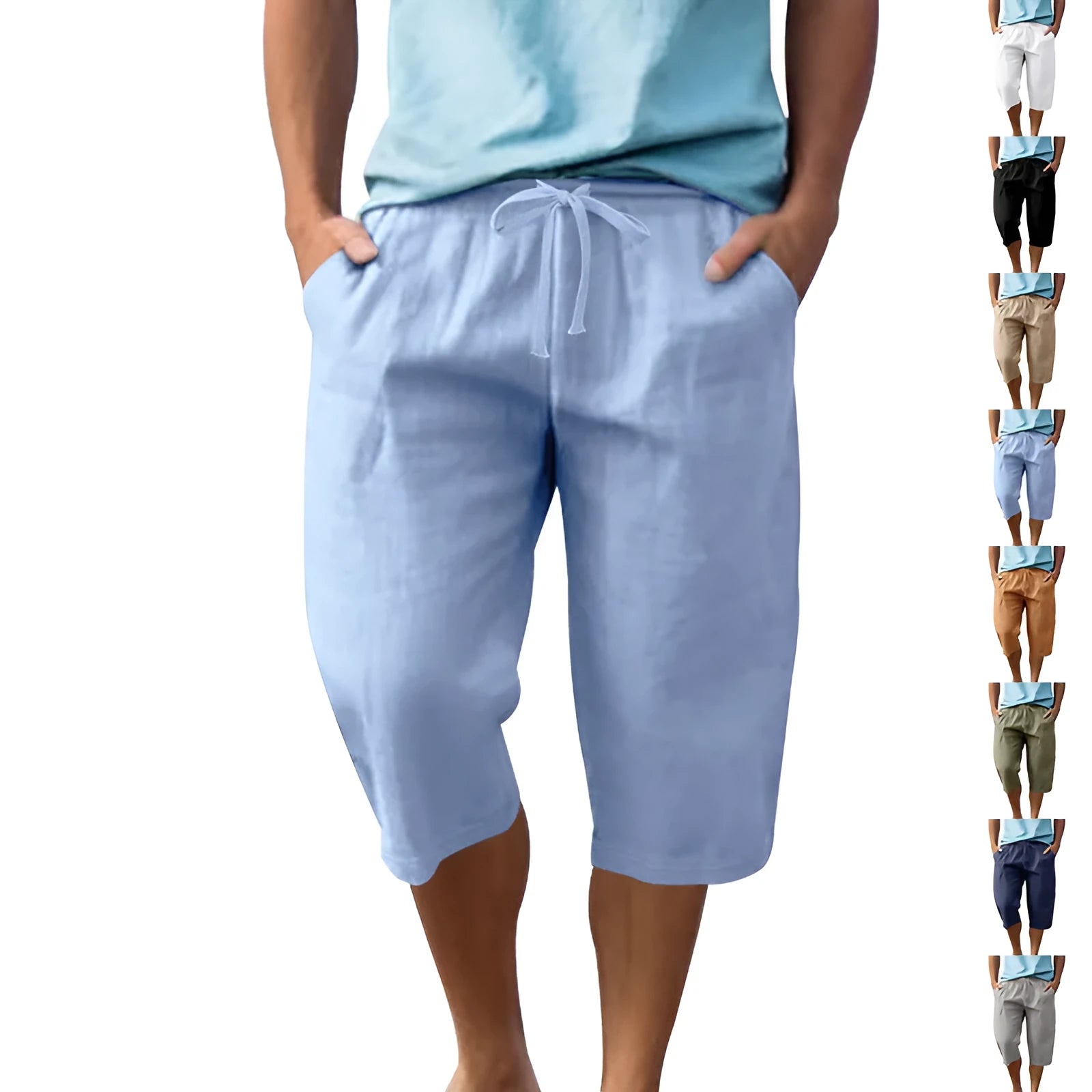 Man wearing loose-fit, solid-colour linen shorts in a light blue shade, showing the cropped length and drawstring waist.