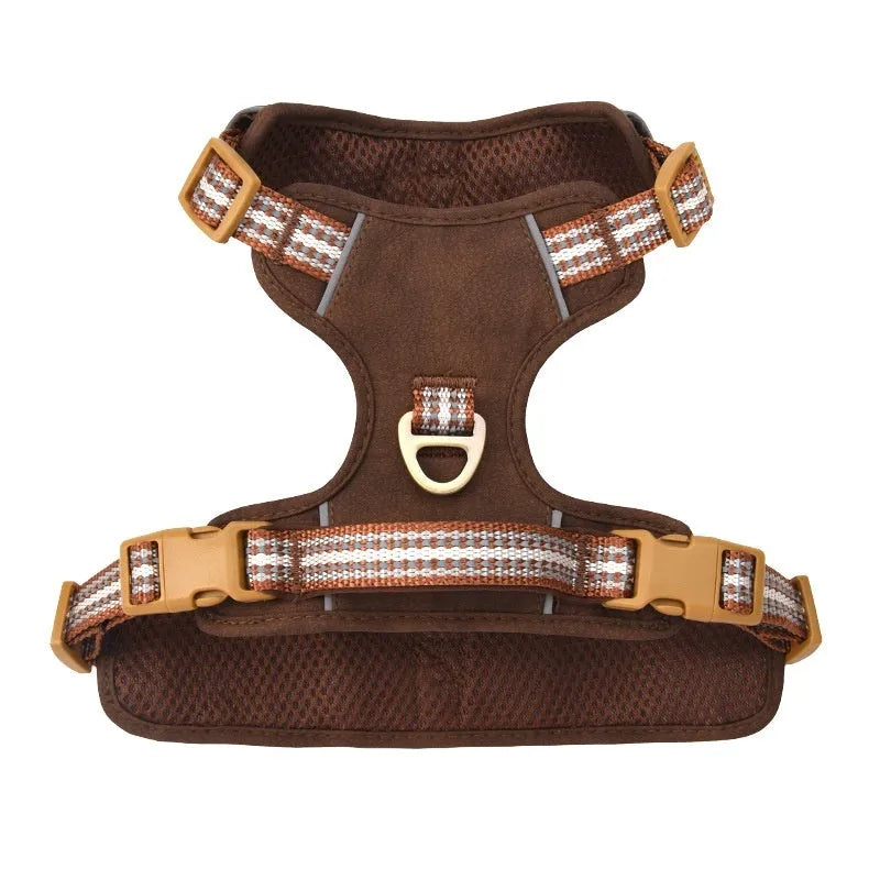 Brown leather dog harness with reflective strips showing buckle closure and adjustable chest strap