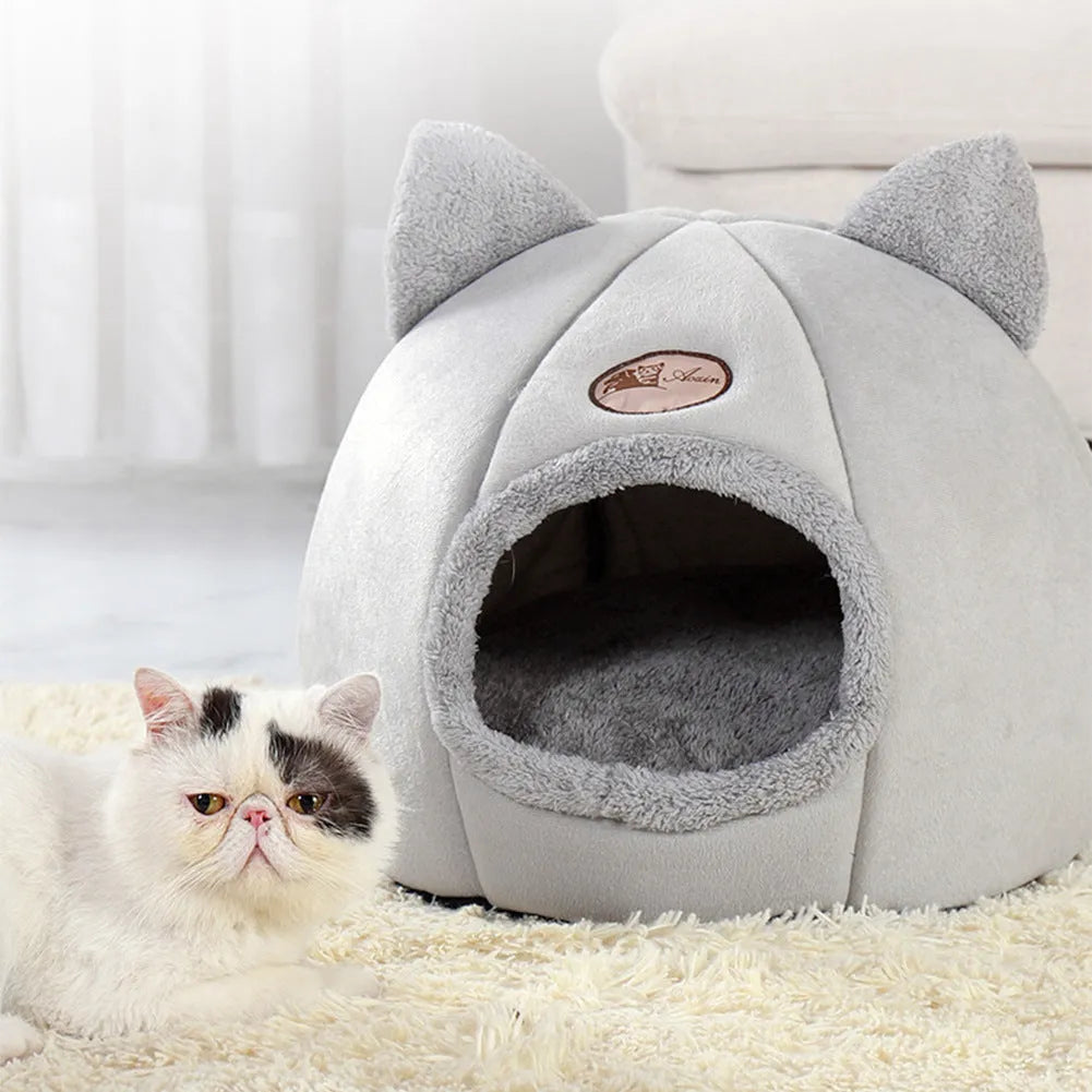 Grey enclosed cat sofa bed with a round entrance hole, showing a soft plush interior and removable cushion.