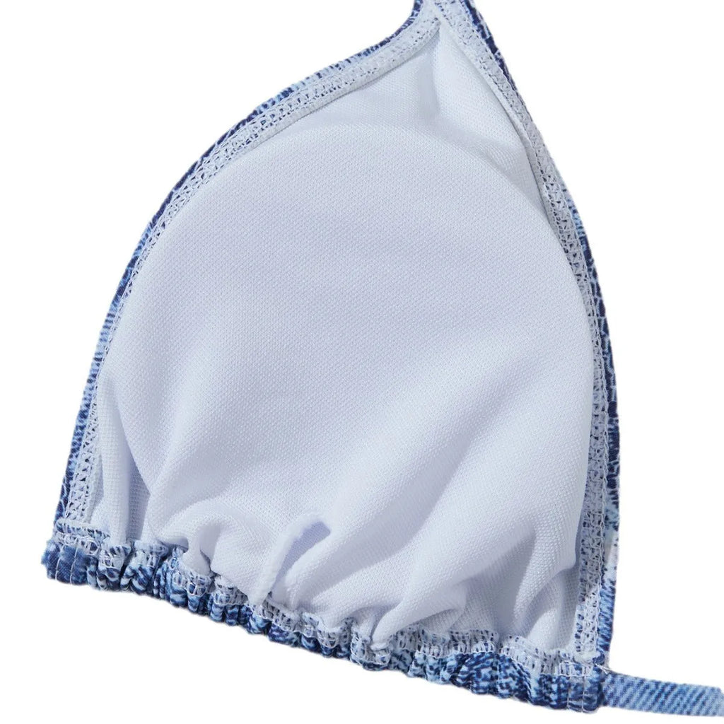 Denim blue printed women's two-piece bikini with thin straps, laid flat.