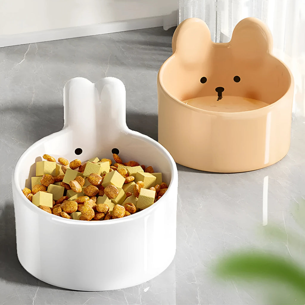 White and yellow ceramic pet bowls with rabbit and bear motifs in two sizes
