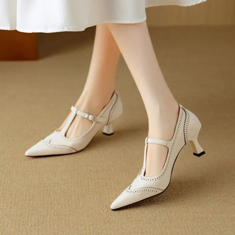 Women's black high heel pump with skull engraving and stiletto heel on white background