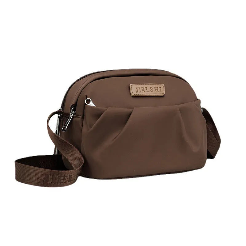 Pleated Oxford cloth shoulder messenger bag in horizontal square shape with cross-body strap