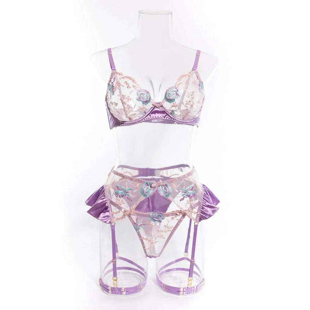 Light purple satin lingerie four-piece set with embroidery detail on a mannequin.