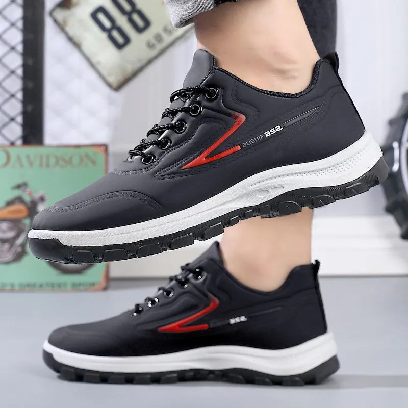 Men's black and grey waterproof PU casual shoes with a pointed toe and flat plastic sole on a white background.