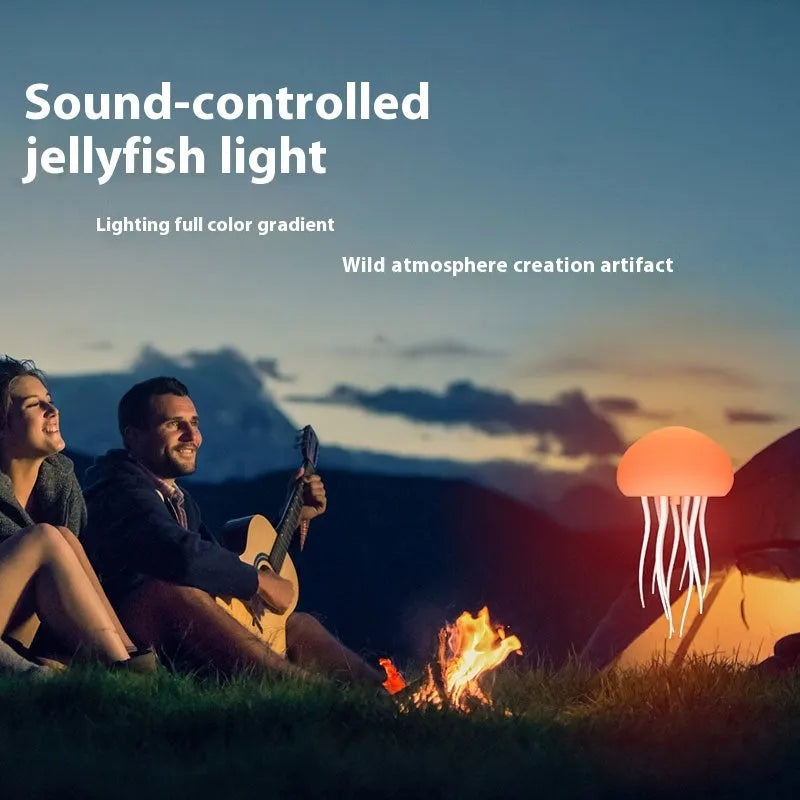 Jellyfish mood lamp with glowing adjustable tentacles on a desk next to a phone.