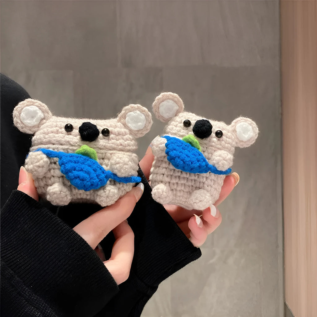 Hand-knitted grey koala bear design cover on a white Airpods case.