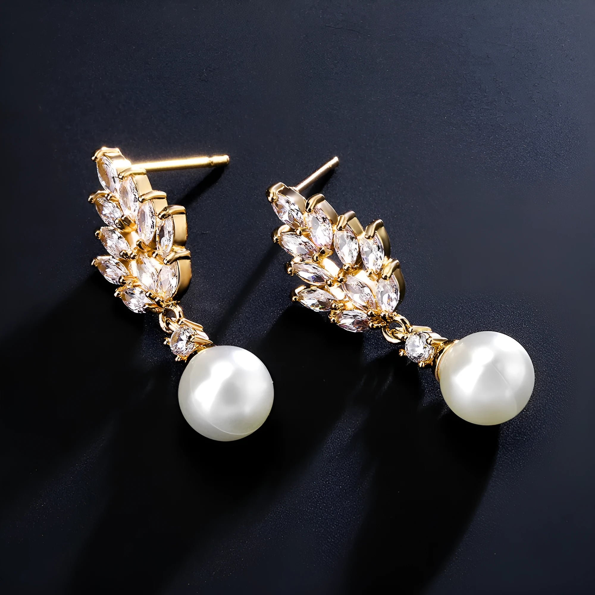 Geometric flower-shaped earrings with micro inlaid zircon and pearl details on a gold-toned metal base.