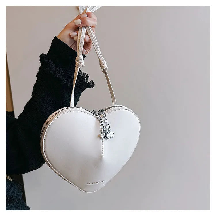 Heart shape women's shoulder bag in milky white PU with single crossbody strap and sewing line detail