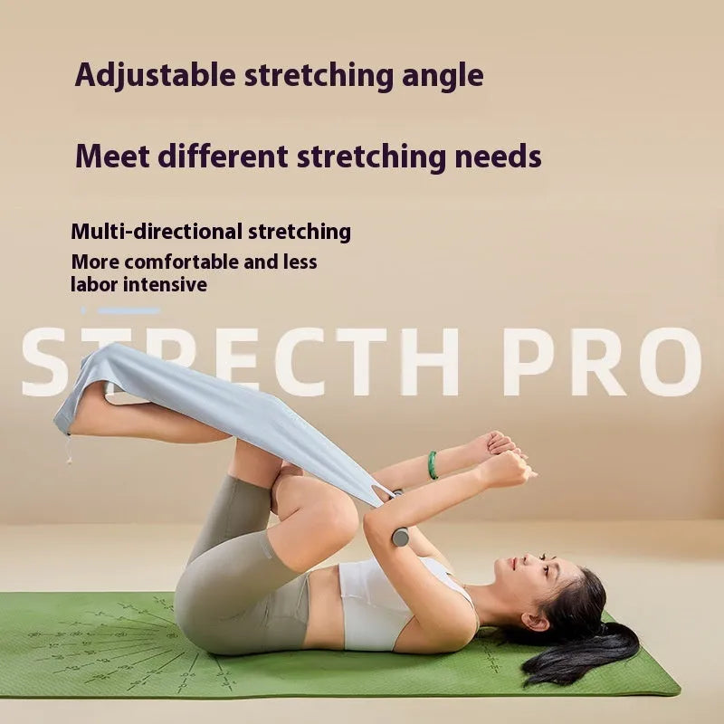 Grey and pink yoga stretching tool for back flexibility and hip opening exercises on a mat.