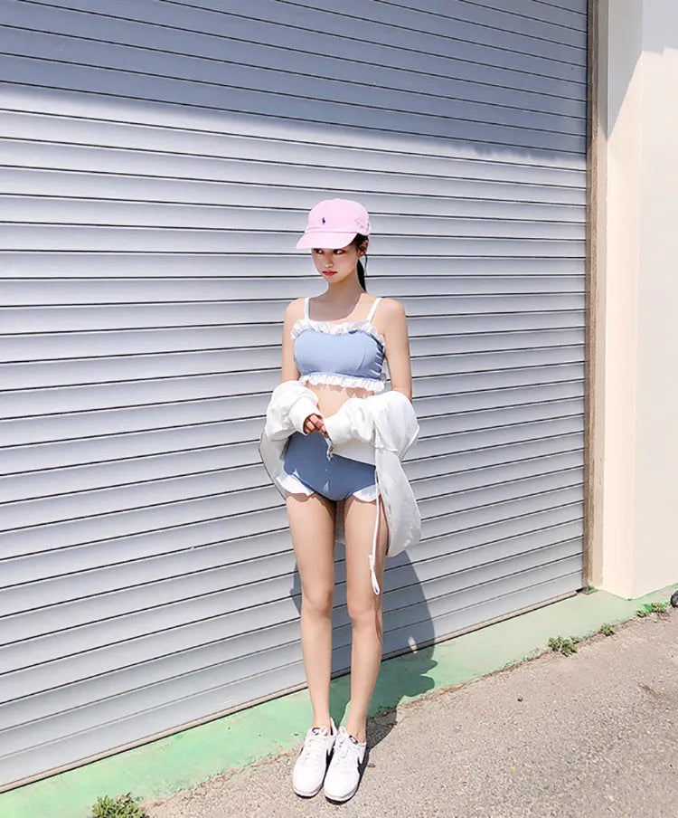 Women's solid colour one-piece swimsuit with fashion suspender straps, conservative cut for swimming.