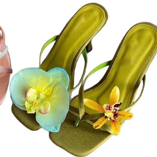 Women's handmade asymmetric flower high-heel sandals in black with a square toe and calf leather upper.
