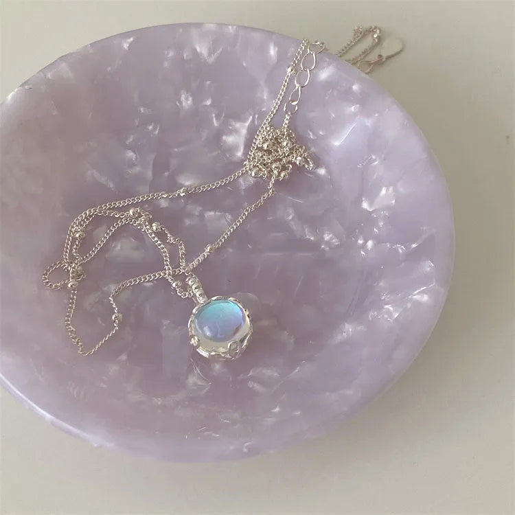 Silver geometric stone necklace on a curb chain, showing adjustable length and polished pendant.