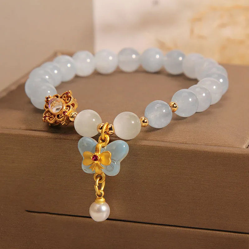 Women's crystal bracelet with aquamarine butterfly pendant and rhinestone details