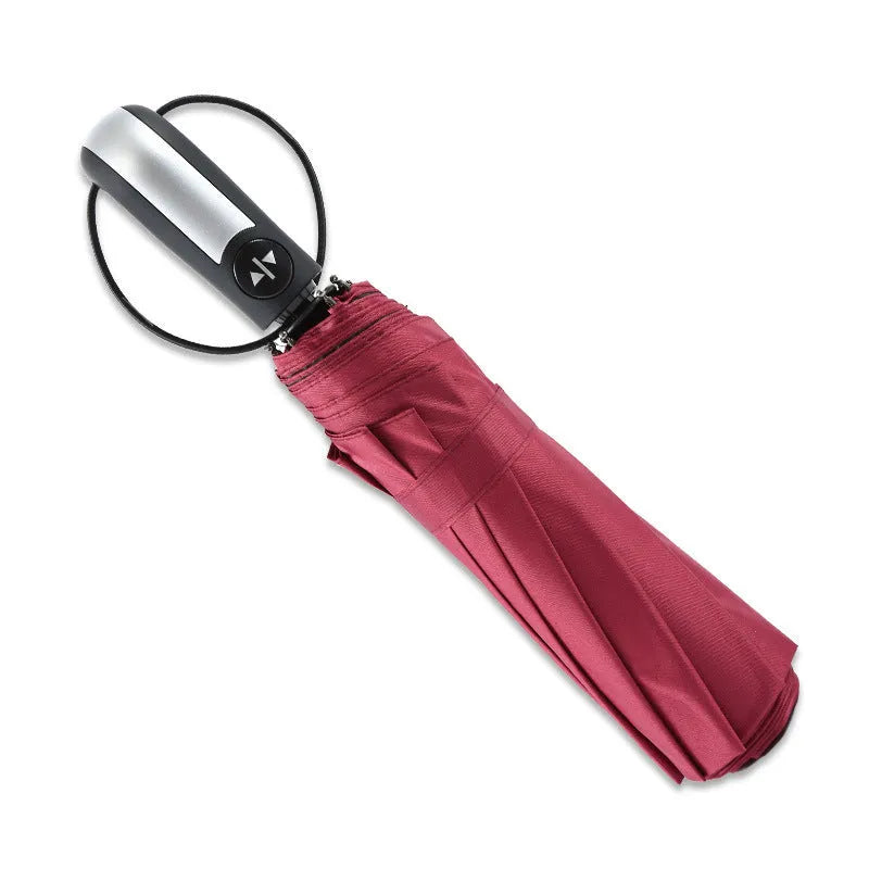 Automatic open triple-fold large sun shade umbrella in black with a rubber handle.
