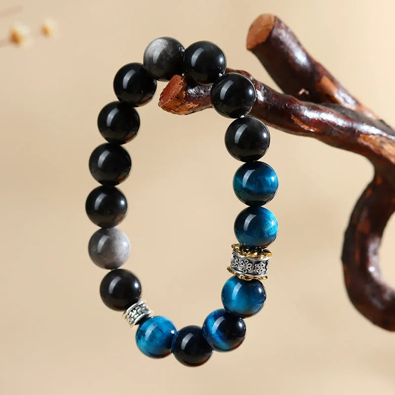 Handmade peacock blue tigereye stone bracelet with geometric design and silver accents