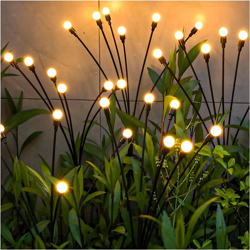 Solar-powered LED garden spike light with multiple firefly-like heads and a push-in pneumatic ground plug.