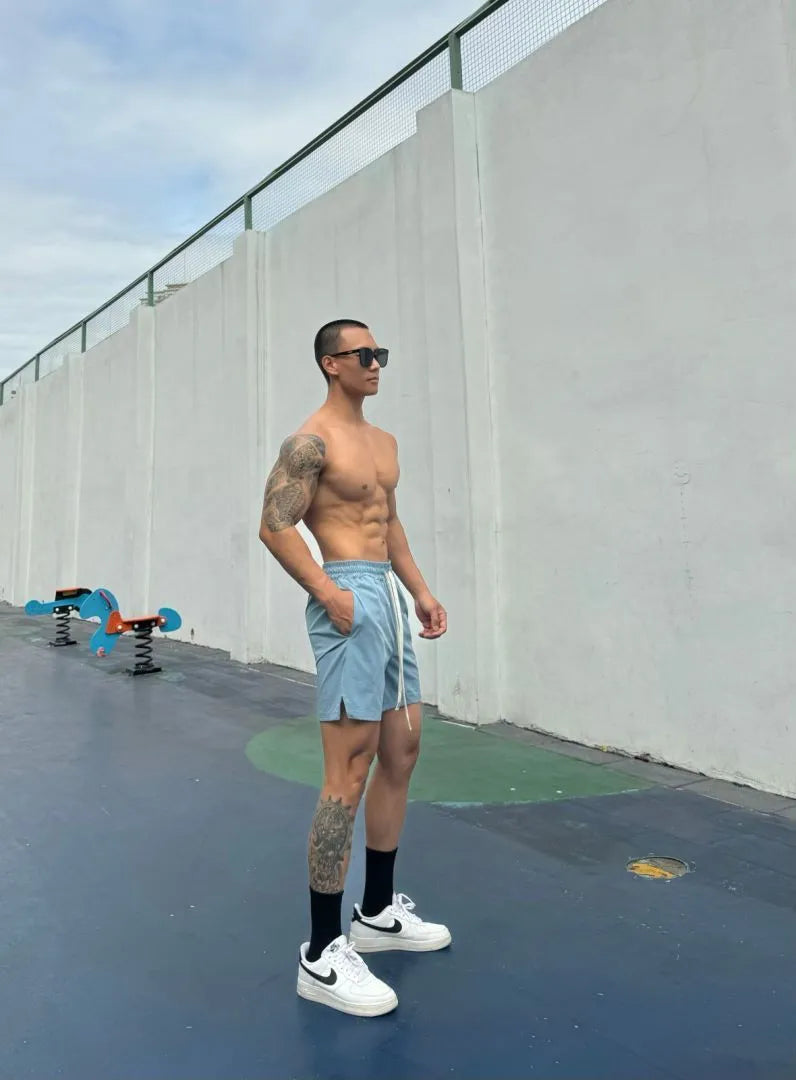 Men's ice silk quick-drying double-layer casual shorts in black, shown on a model.