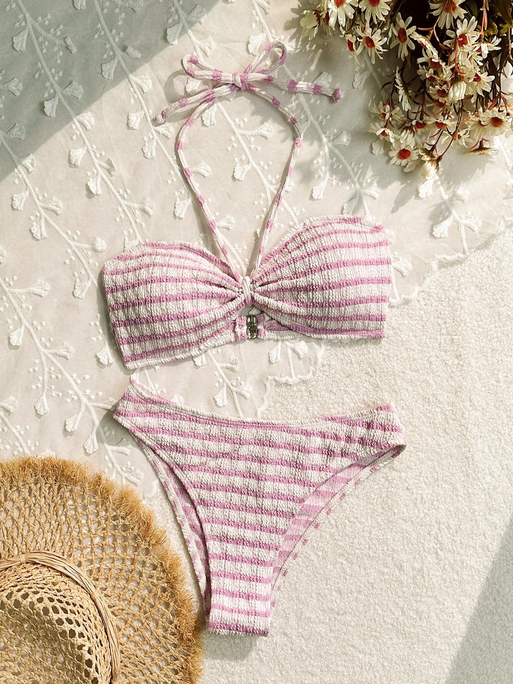 Women's pink and black striped bikini swimsuit with solid briefs.
