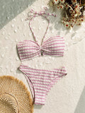 Women's pink and black striped bikini swimsuit with solid briefs.