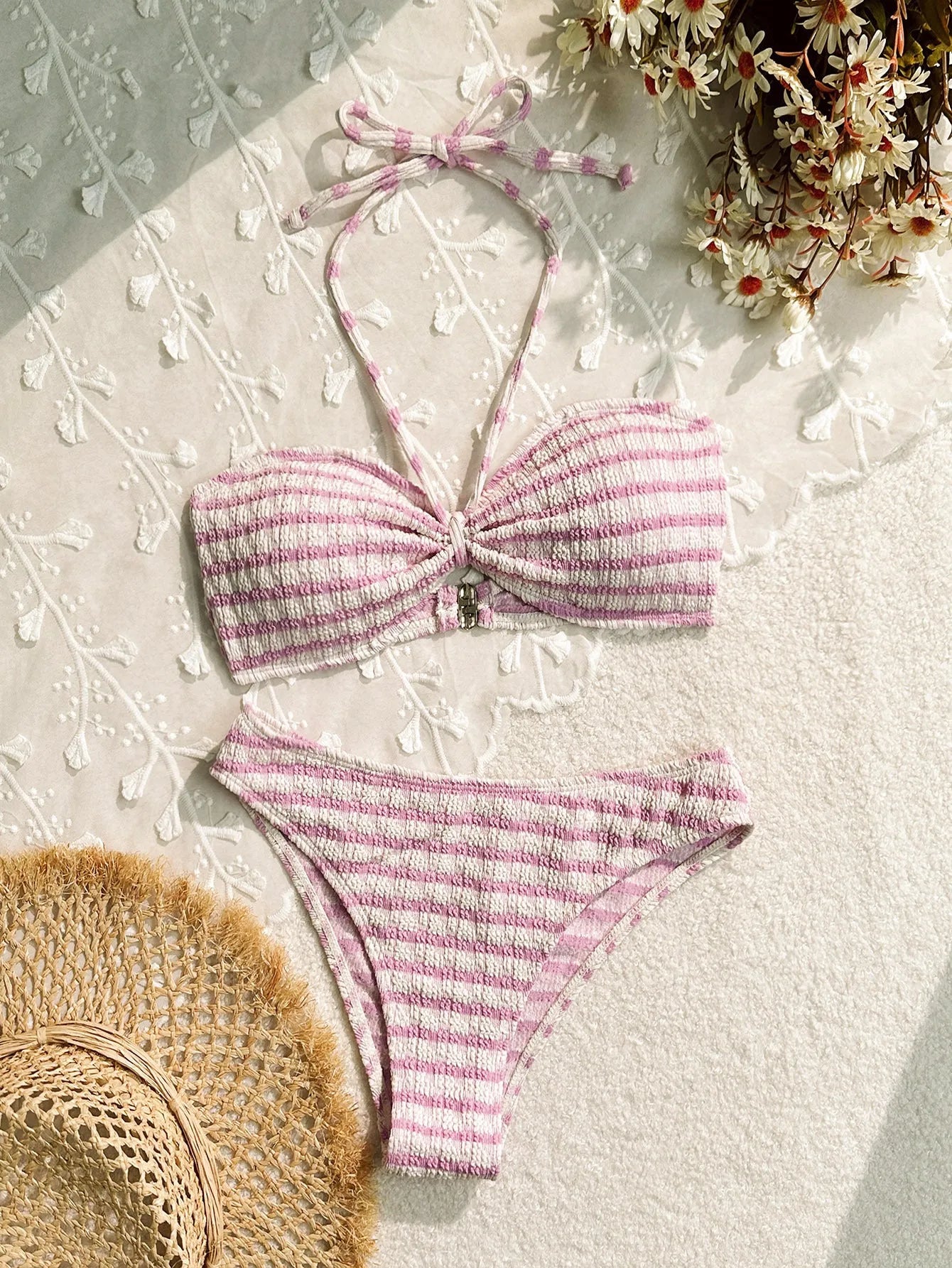 Women's pink and black striped bikini swimsuit with solid briefs.