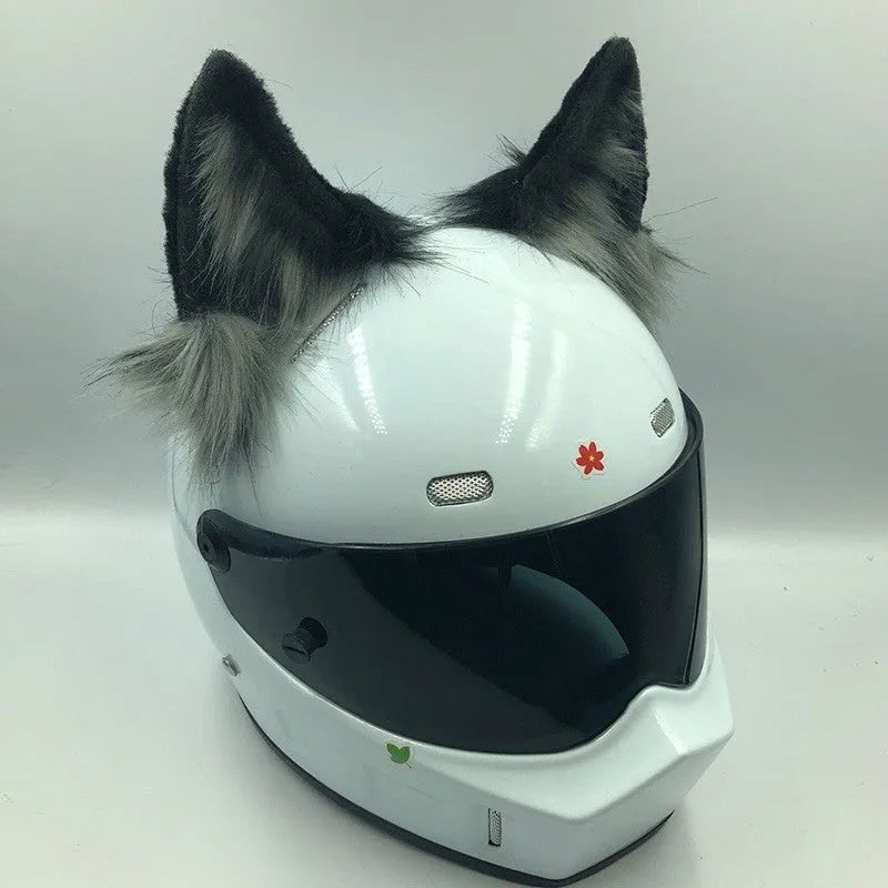 Set of black and white wolf ear and tail ornaments clipped to a motorcycle helmet