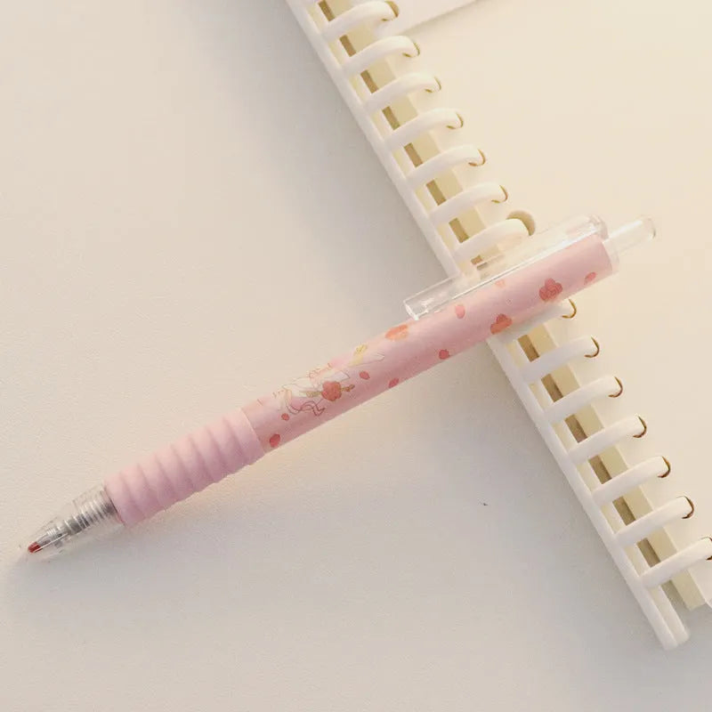 Cute Peach press gel pen with 14cm plastic body and rollerball tip against white background