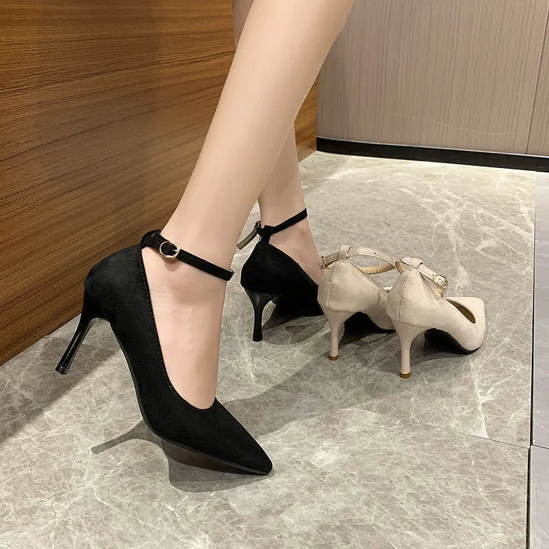 Women's black skull pattern stiletto heel pumps with buckle detail on rubber sole