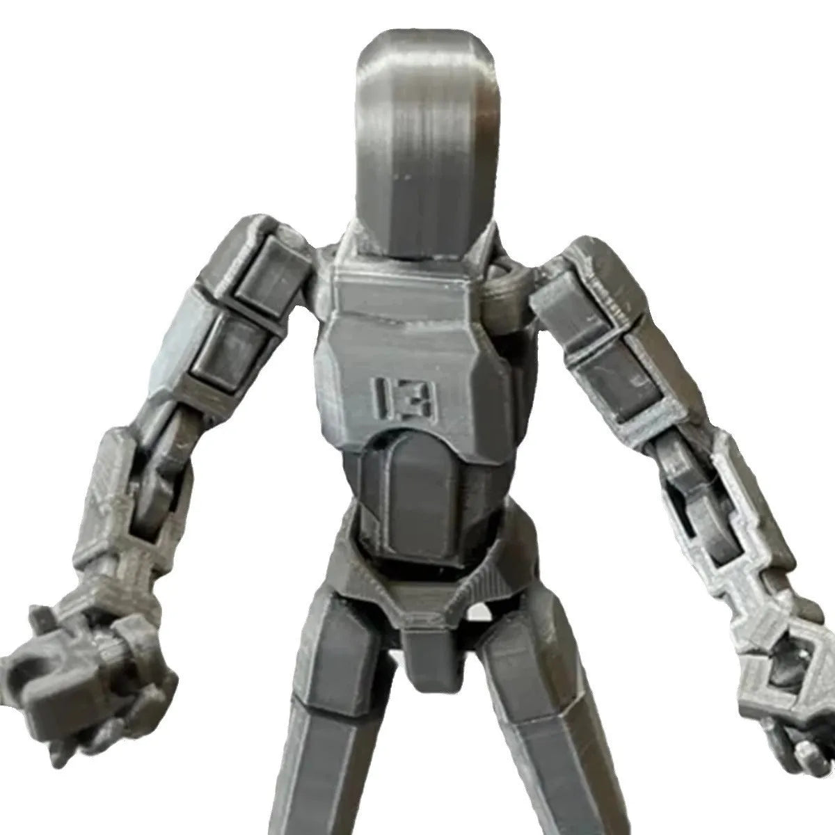 3D printed multi-jointed robot action figure model with movable joints on a desk.