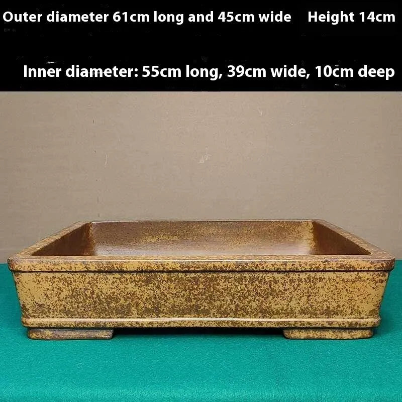 Straight-sided shallow rectangular Yixing purple Zisha clay flowerpot on a wooden surface.