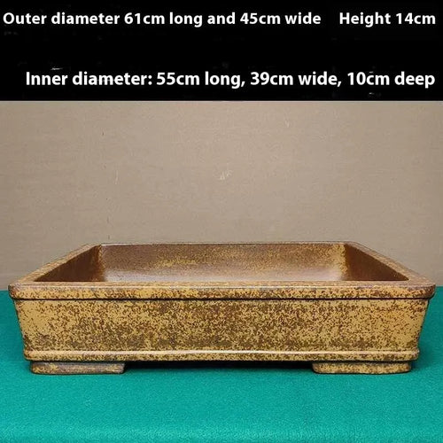 Straight-sided shallow rectangular Yixing purple Zisha clay flowerpot on a wooden surface.