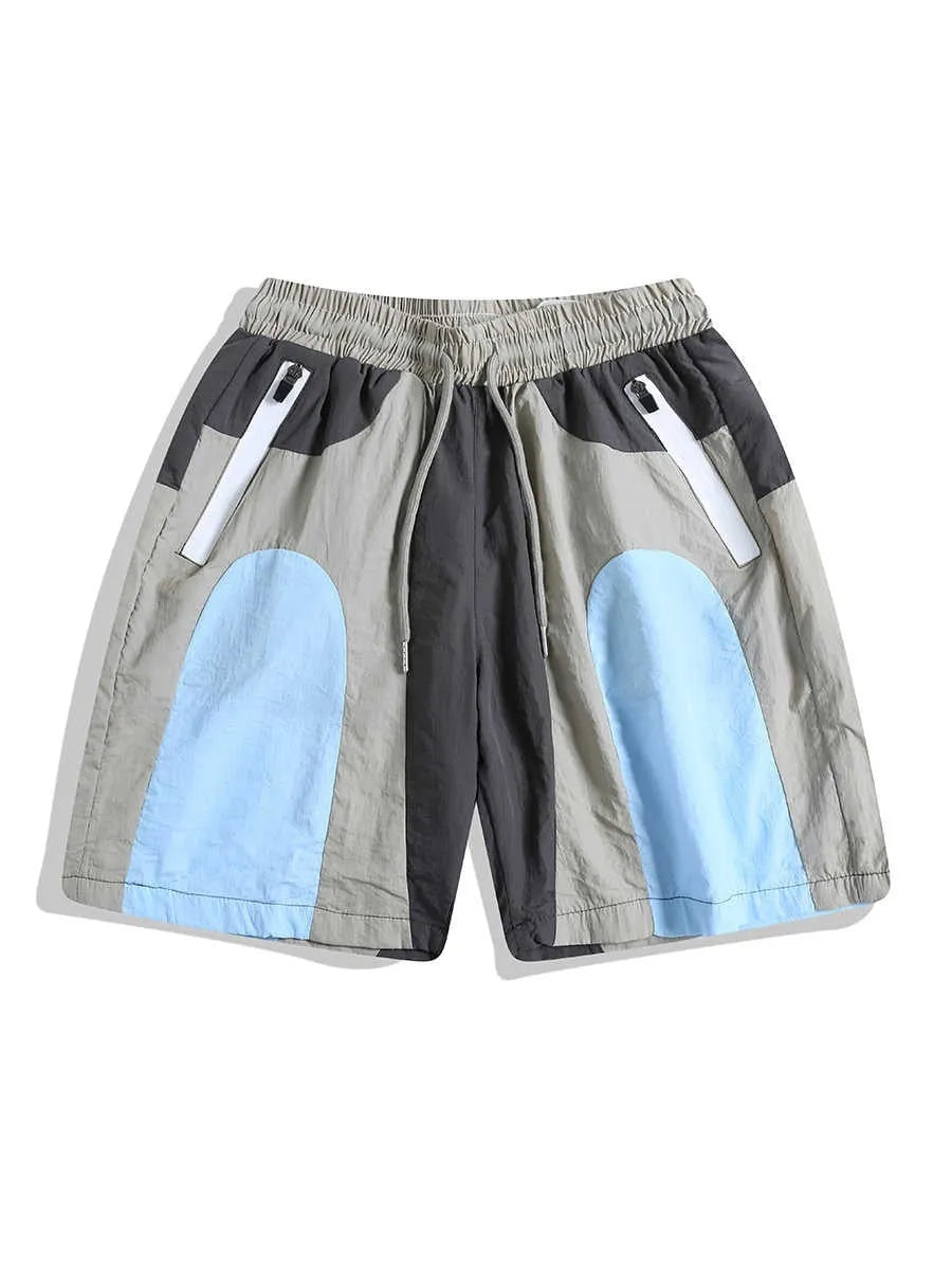 Man wearing blue patchwork loose-fit quick-drying casual sports shorts.